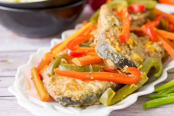 Slices of fish with steamed veggies on top