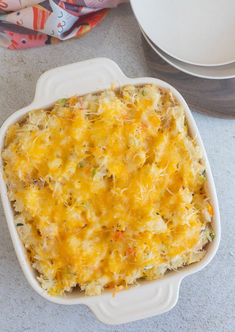 Cheesy baked cassava and fish pie in a casserole dish.