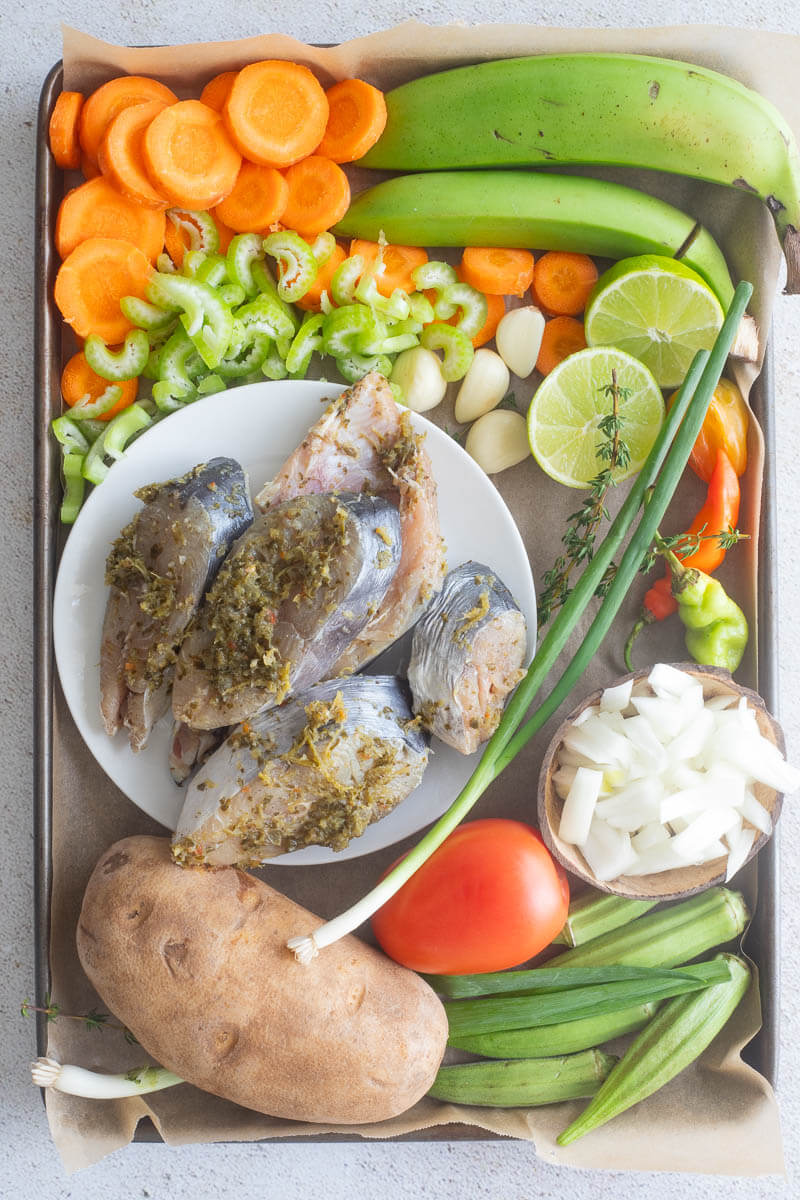 Ingredients needed to make fish broth on a silver tray.