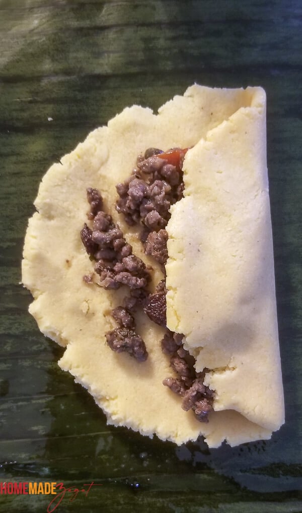 dough with meat filling with one side of dough folded in