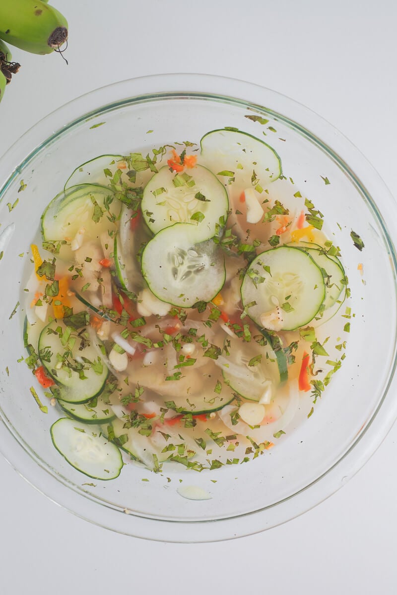 All the ingredients combined to make the green fig souse on a white counter.