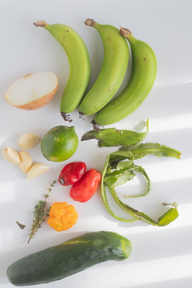 The ingredients needed to make green fig souse on a white cutting board.