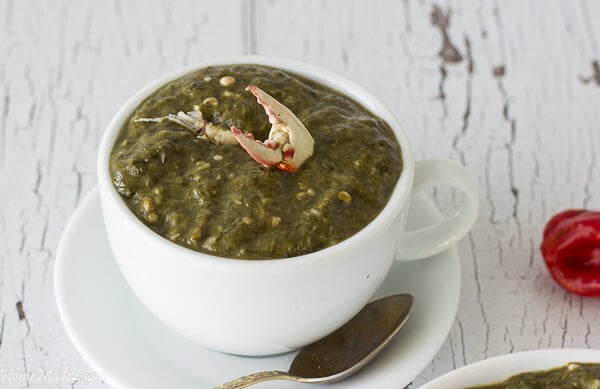 A cup full of callaloo showing it can be eaten as soup.