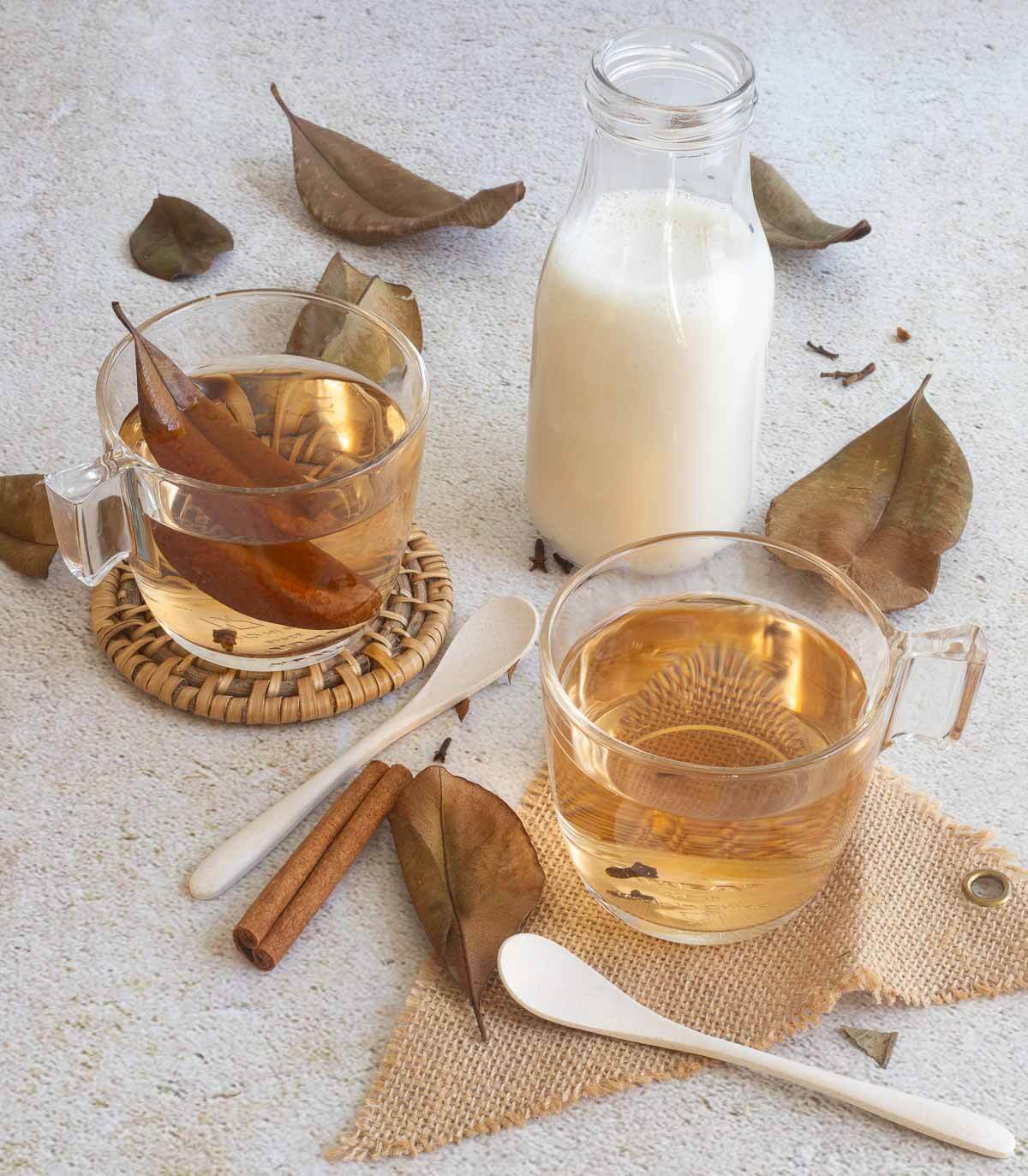 Deliciously brewed bay leaf tea in a glass cup with cloves and cinnamon.