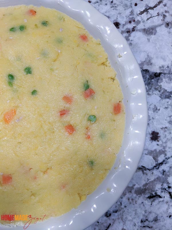 Cornmeal coo coo cooked and set in a bowl and buttered.