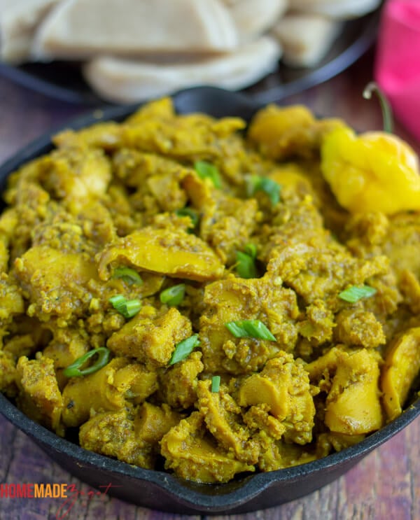 Close up of curry conch in a black dish