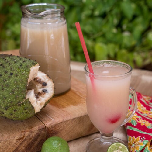 Jug and glass of soursop drink with soursop.
