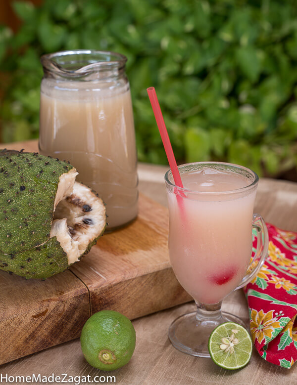 Jug and glass of soursop drink with soursop.