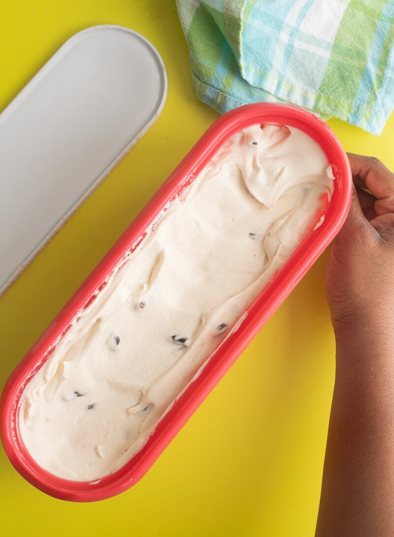 Ice cream in a red ice cream tub to be frozen.