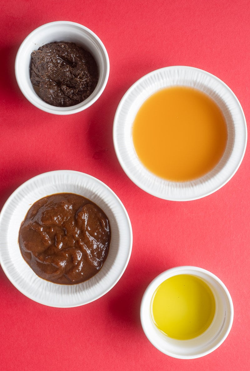 Ingredients to make the jerk sauce to accompany the jerk chicken portioned out into containers.
