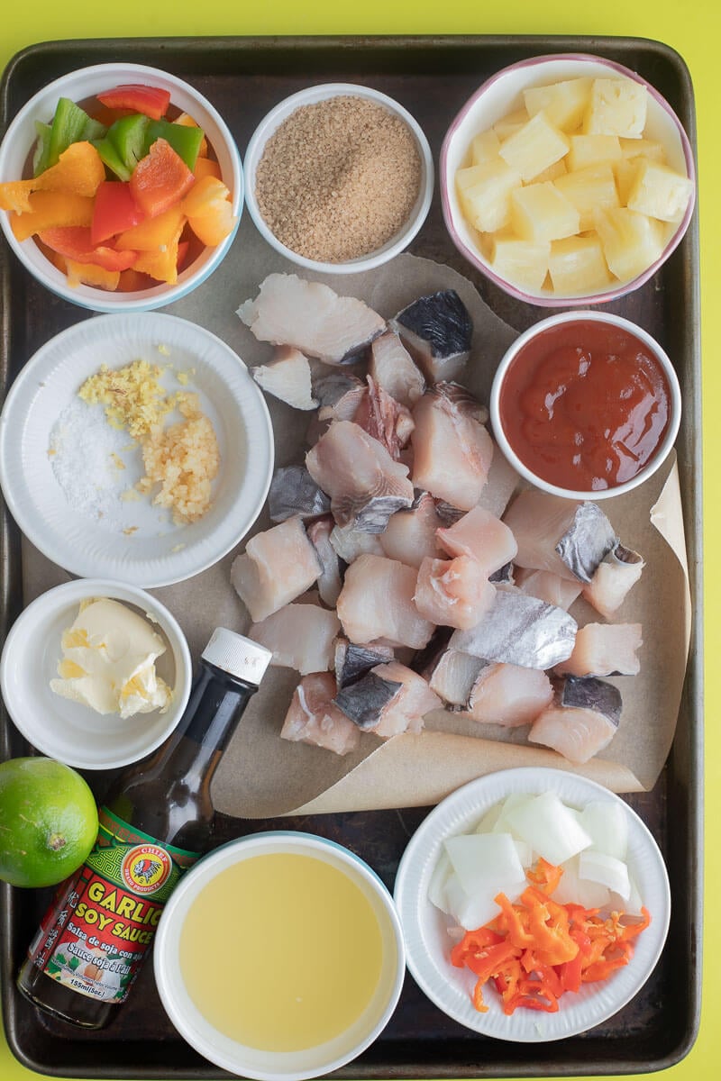 Ingredients for sweet and sour fish on a baking tray.