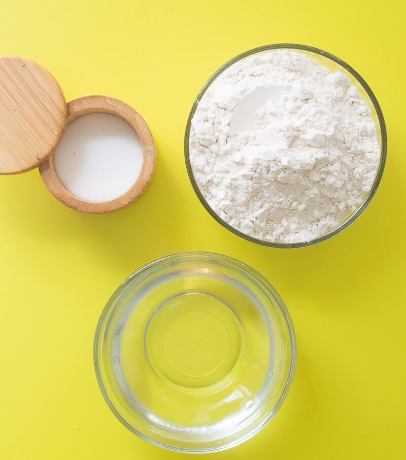 Ingredients needed to make boiled dumplings separated out in bowls.