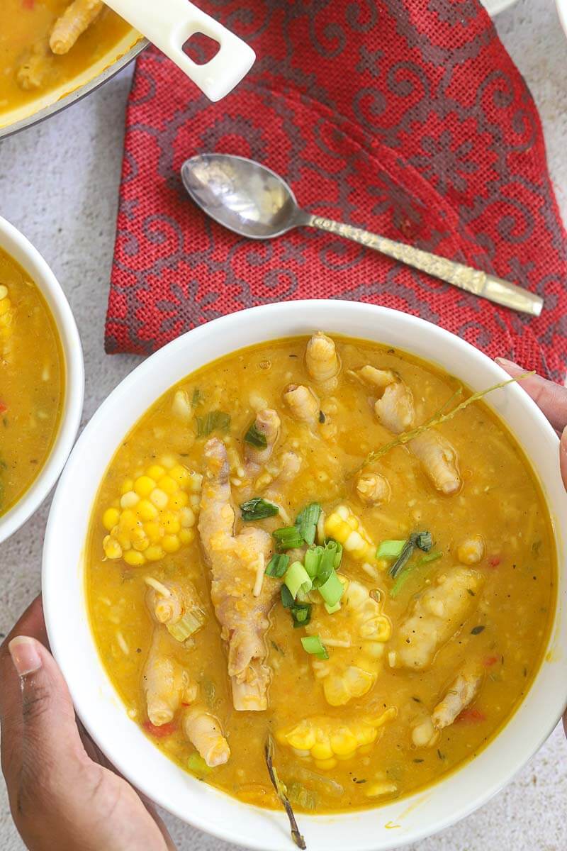 A serving bowl full of chicken foot soup.