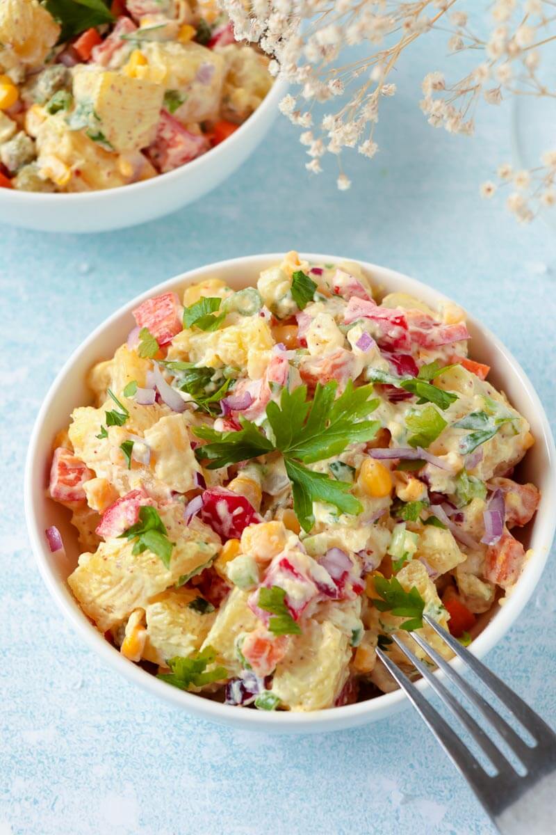 An over head shot of a bowl of the Jamaican potato salad with mixed vegetables.