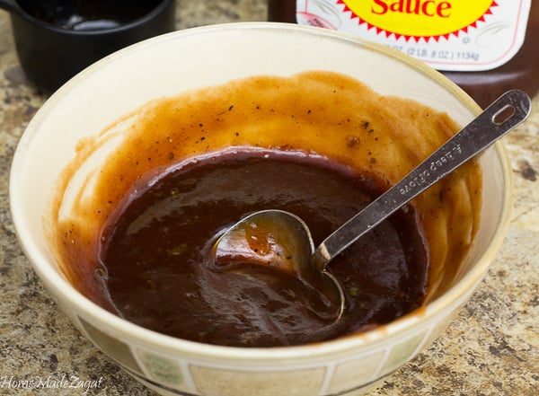A brown bowl with BBQ sauce mixed with jerk seasoning.