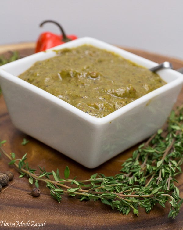 A white bowl of blended Jamaican jerk seasoning paste