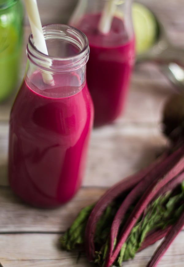 Mixed beetroot punch with milk and spices in a milk jug with condensed milk and ginger.