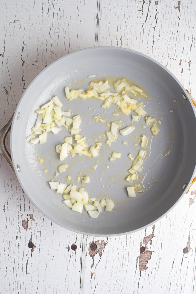 Onions in a skillet with melted butter.