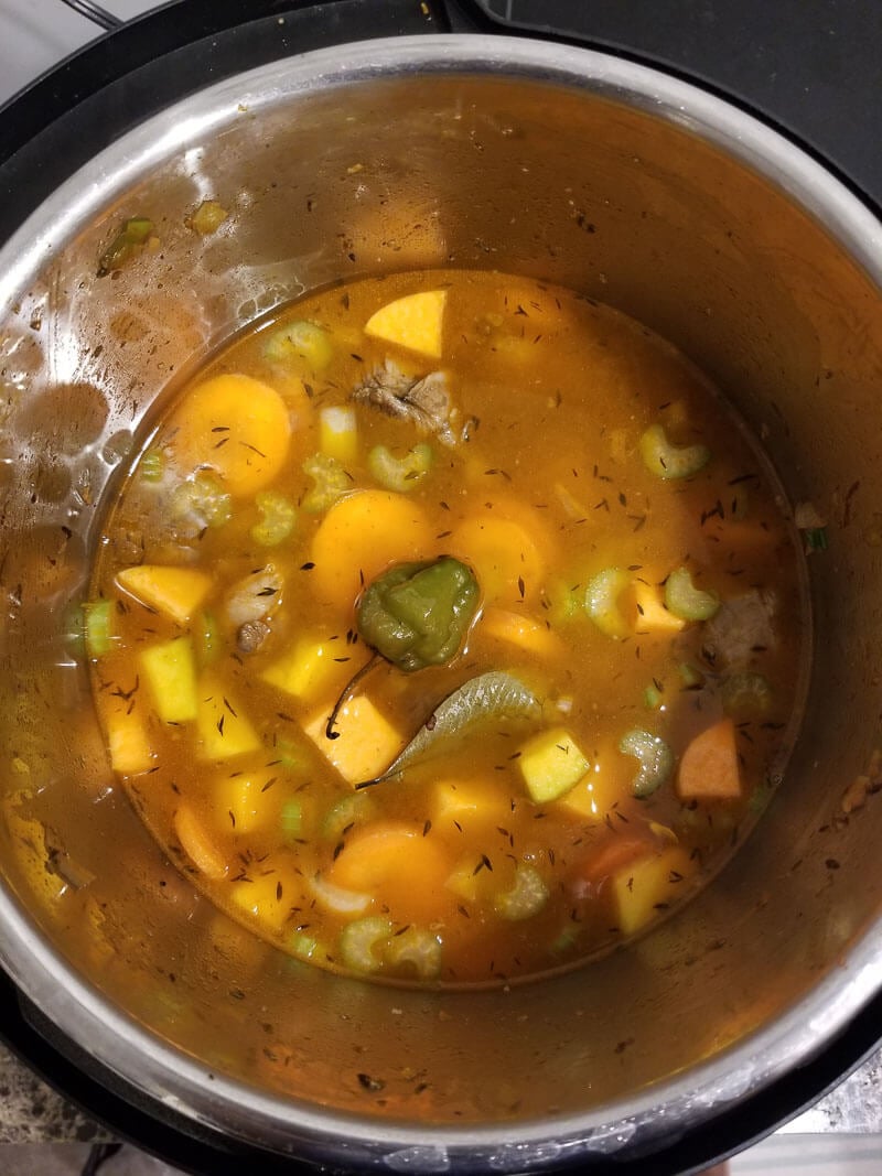 Oxtail with broth and vegetables about to be made into oxtail soup.