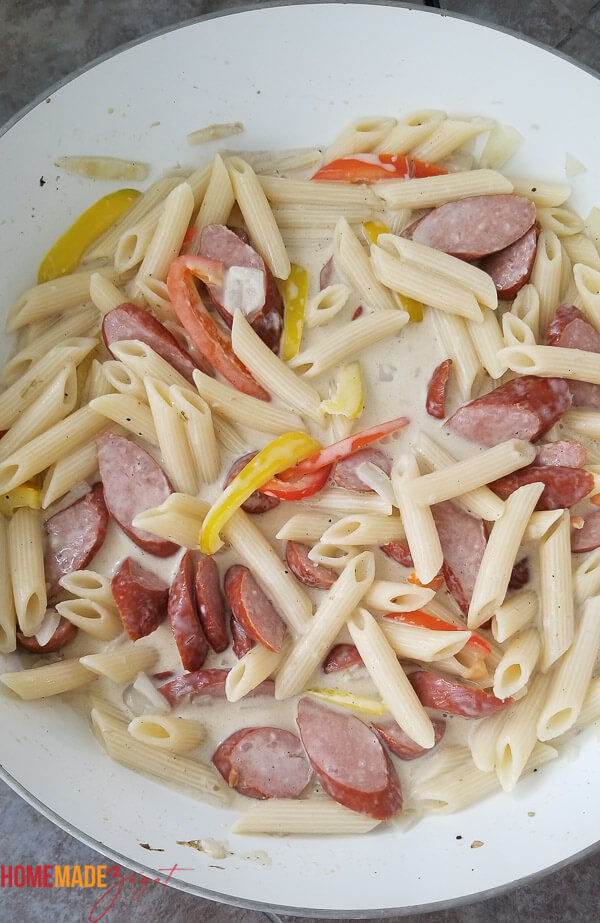 Pasta added to the sausage and coconut milk to now blend flavors.