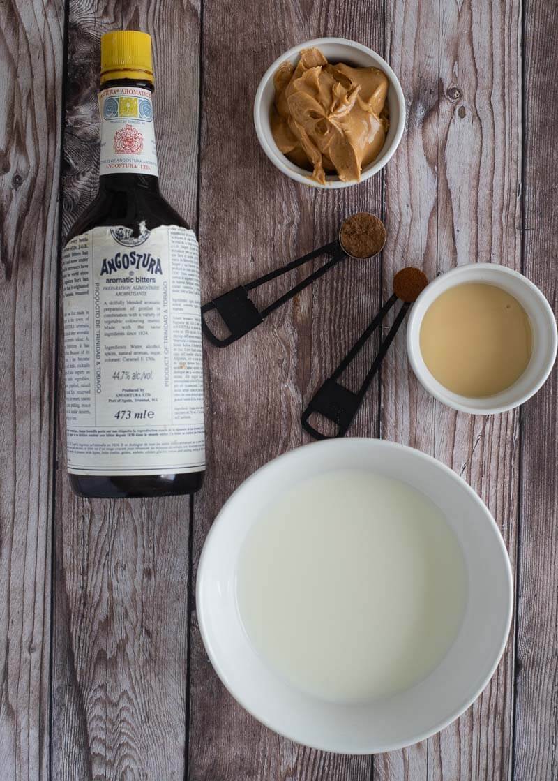 The ingredients needed too make peanut punch shared out on a brown board.