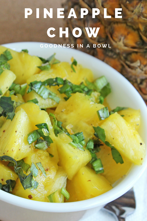 A white bowl of trini pineapple chow with on a brown background.