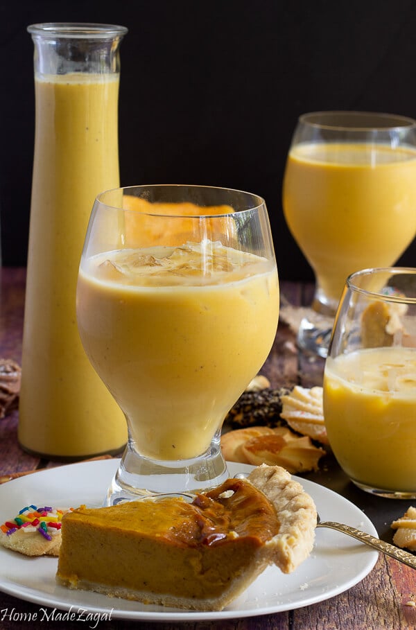 Delicious pumpkin ponche de creme in glasses with cakes and other desserts.