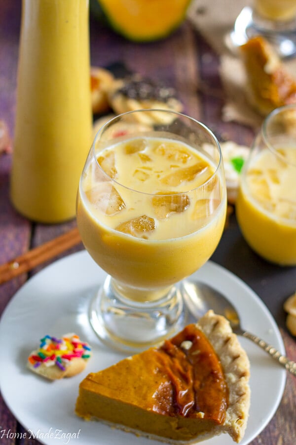 a plate of pumpkin pie with a glass of pumpkin ponche de creme.