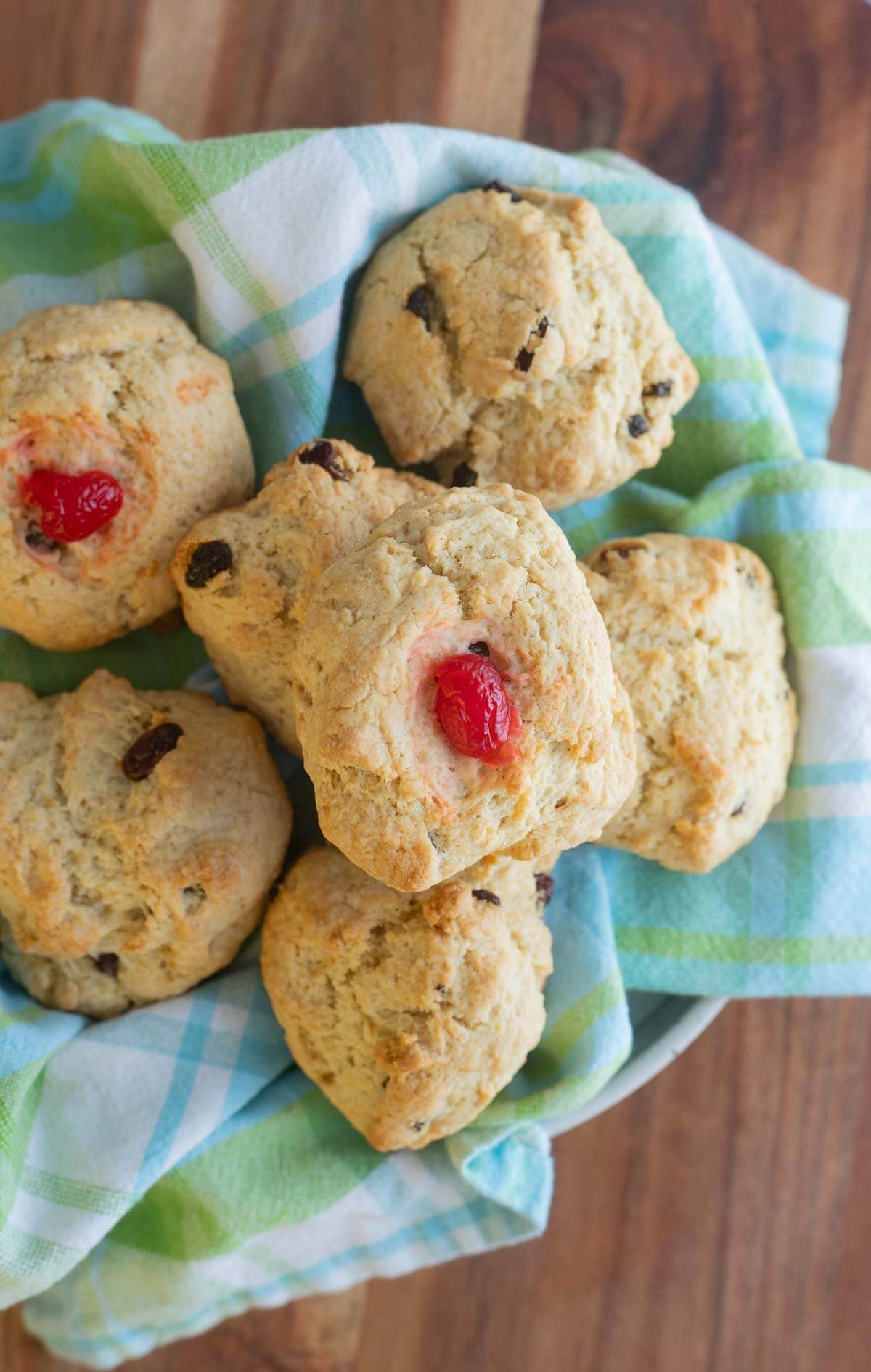 A bowl of baked rock bun with a plaid serving cloth.