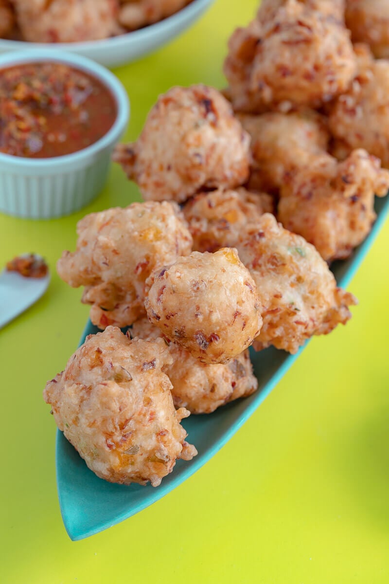 A close up of a ball of fried accra (saltfish cakes).