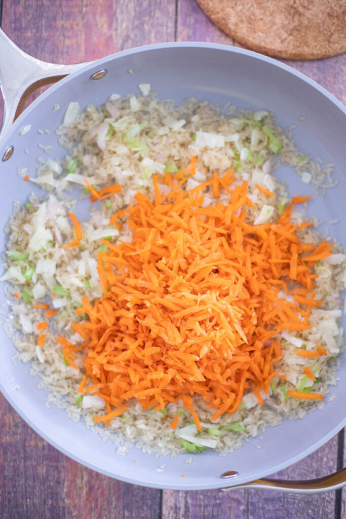 Sweet shredded carrots added to rice and sauteed onions and shallots.