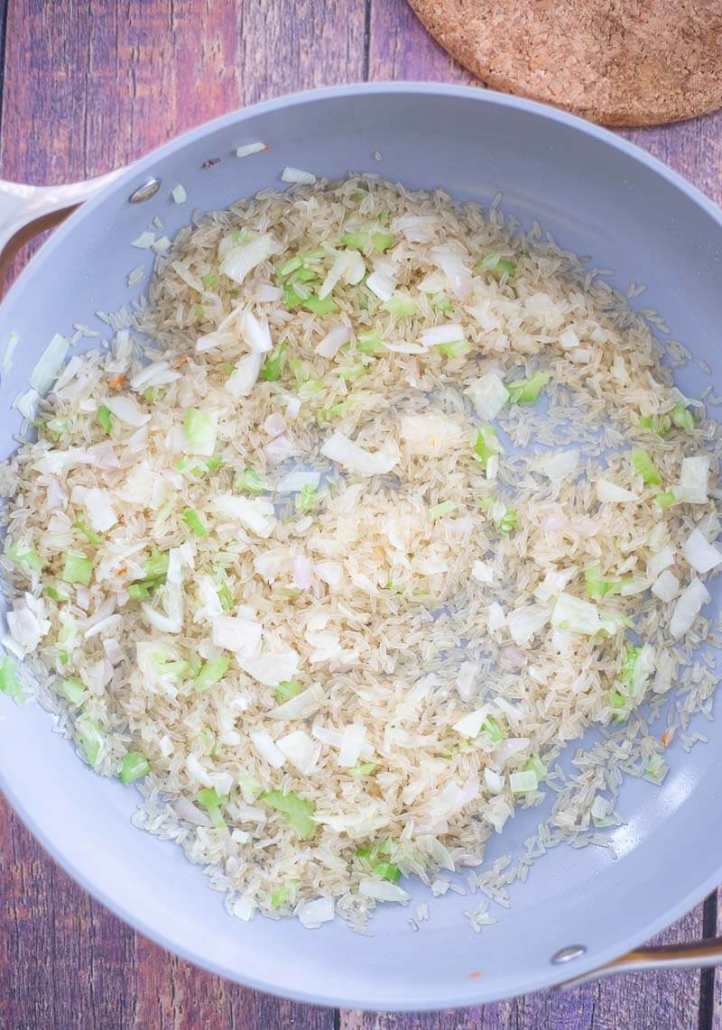 Sweet shredded carrots added to rice and sauteed onions and shallots.