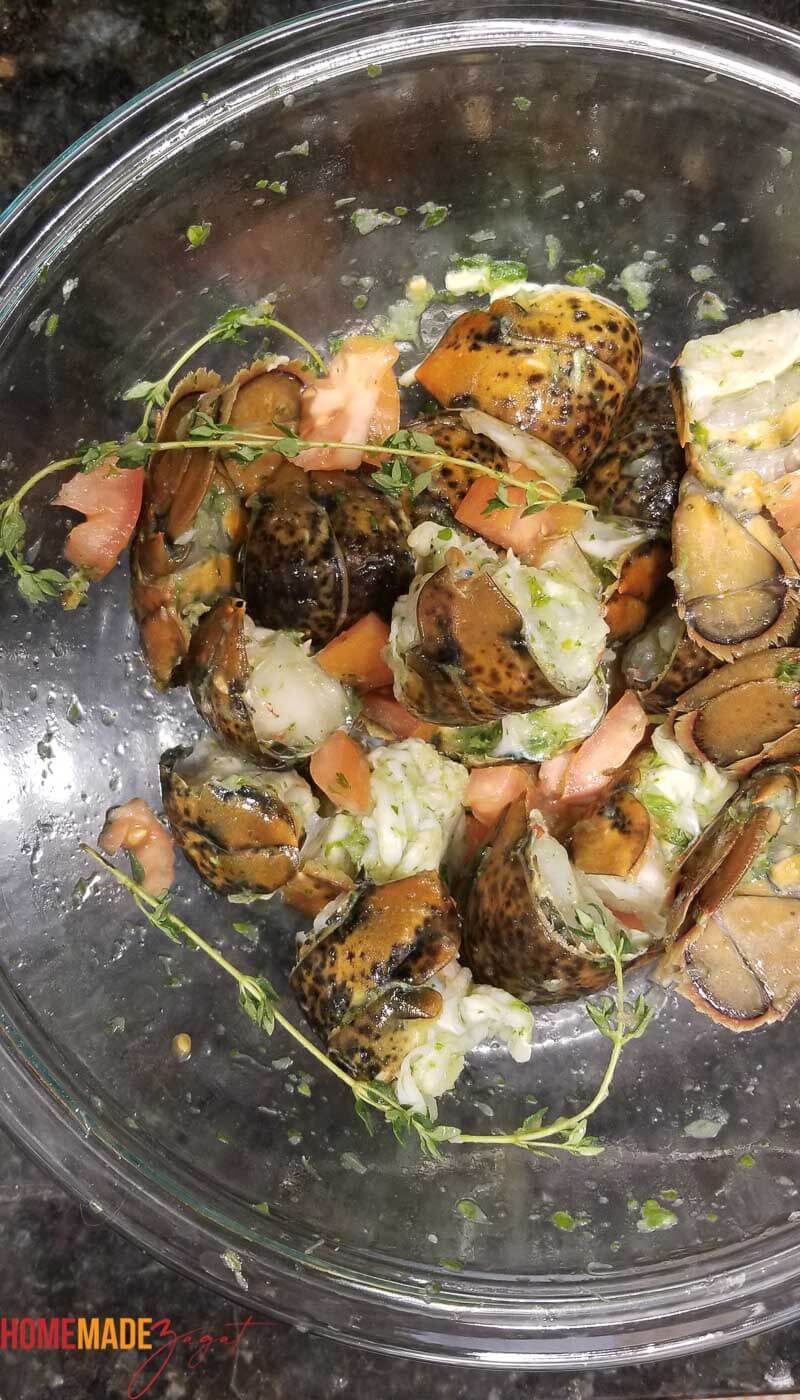 A bowl of seasoned lobsters prior to cooking
