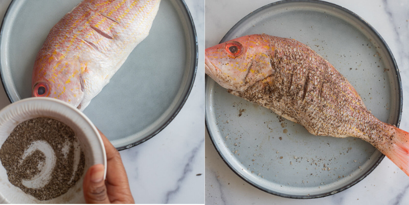Mixing black pepper and salt then seasoning fish with mixture.