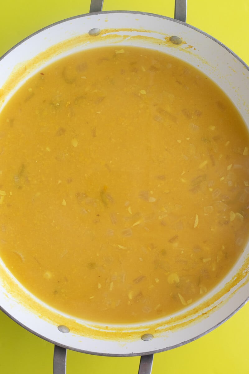 Softened split peas and aromatics simmer down.