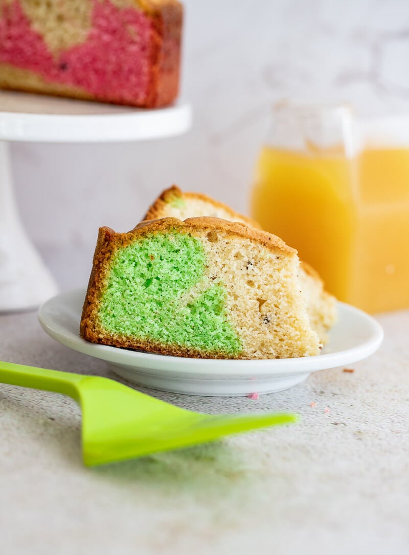 Close up of a slice of Trini marble cake with green food colouring.