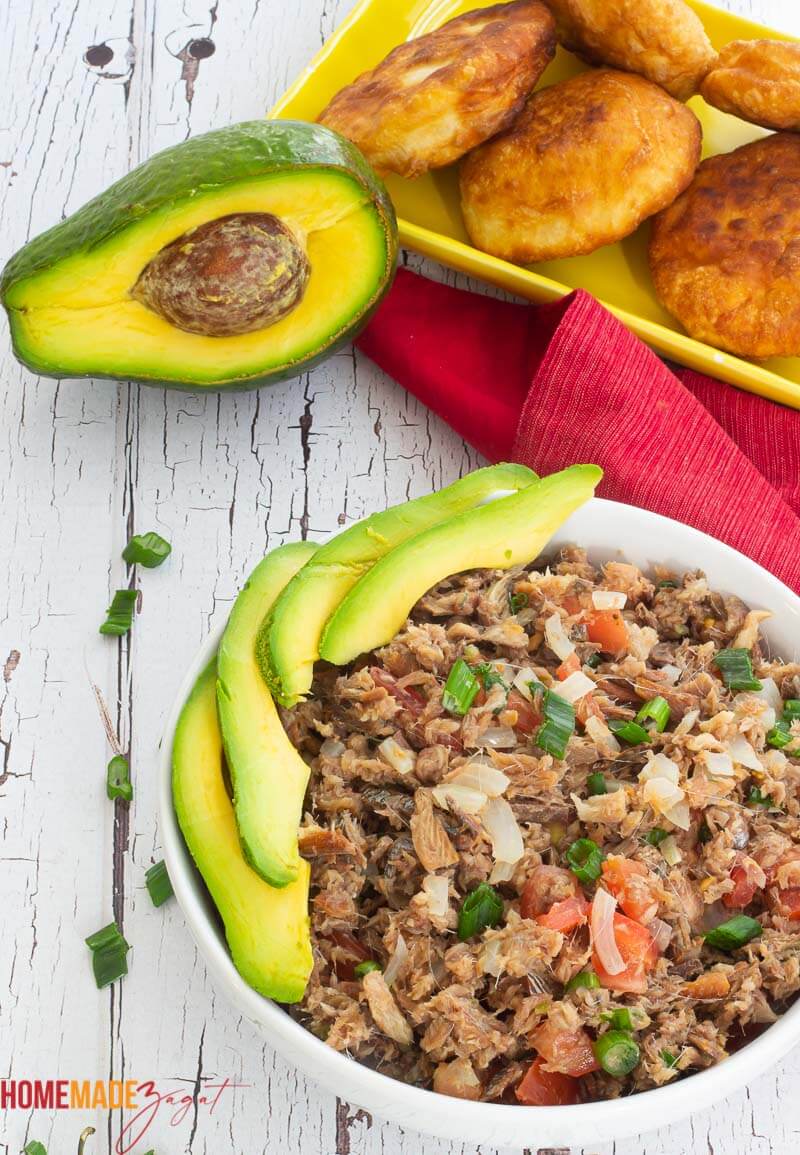 A bowl of smoked herring with avocado slices and an avocado
