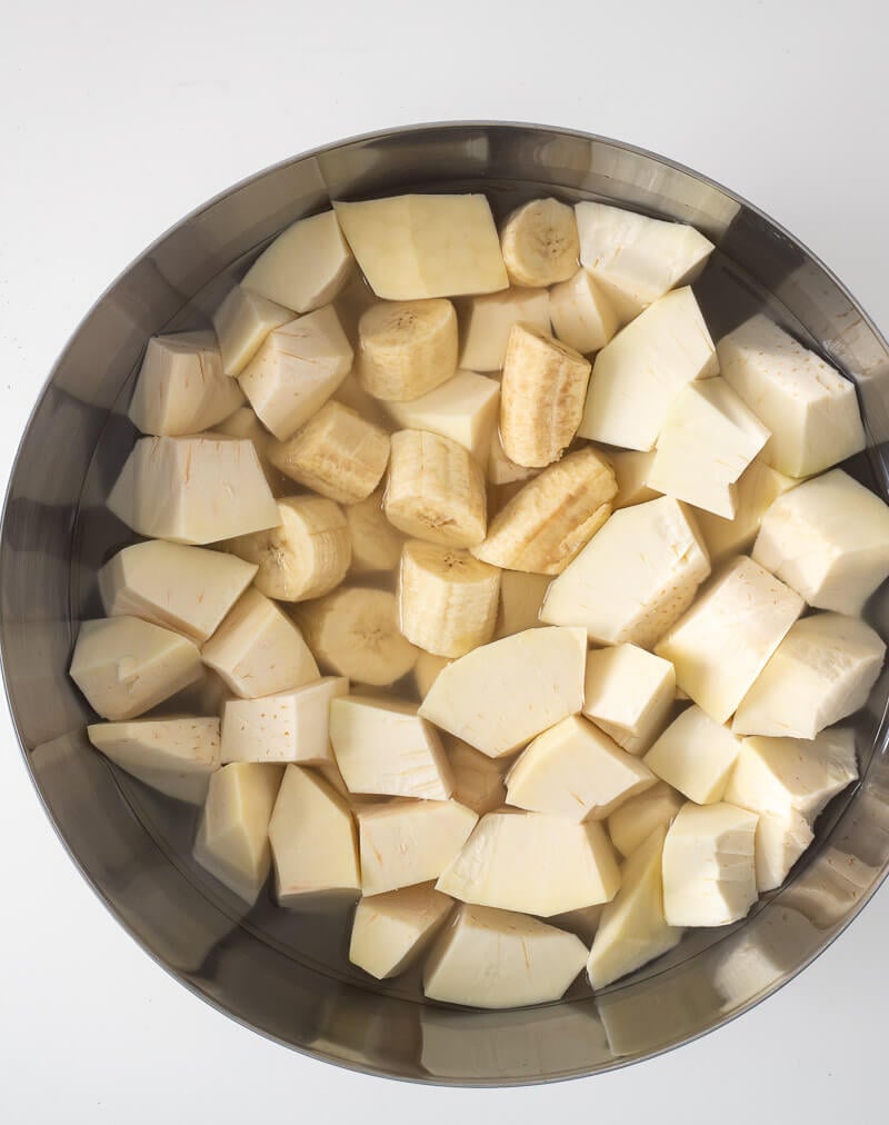 Cut up breadfruit and green banana soaking in water.