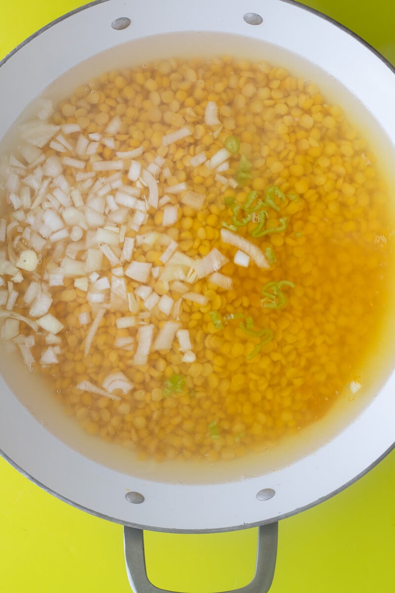 Split peas in water boiling with onion, garlic, turmeric and other aromatics.