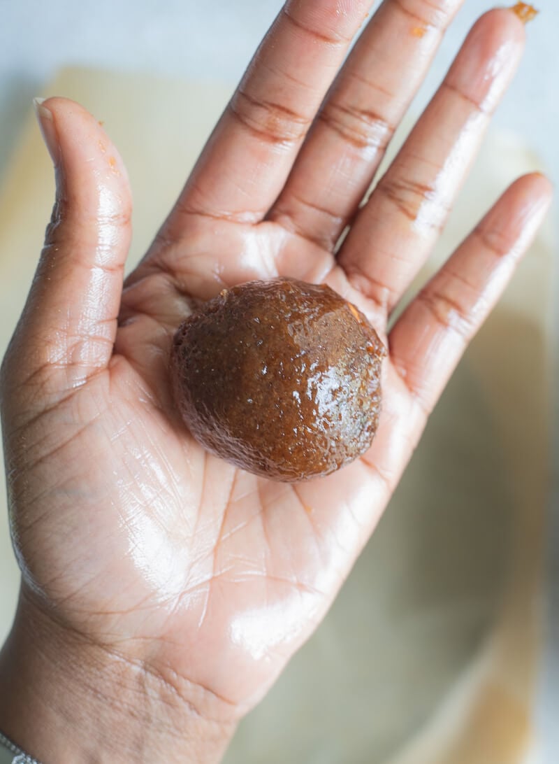 Tamarind pulp shaped into a ball in a greased palm.