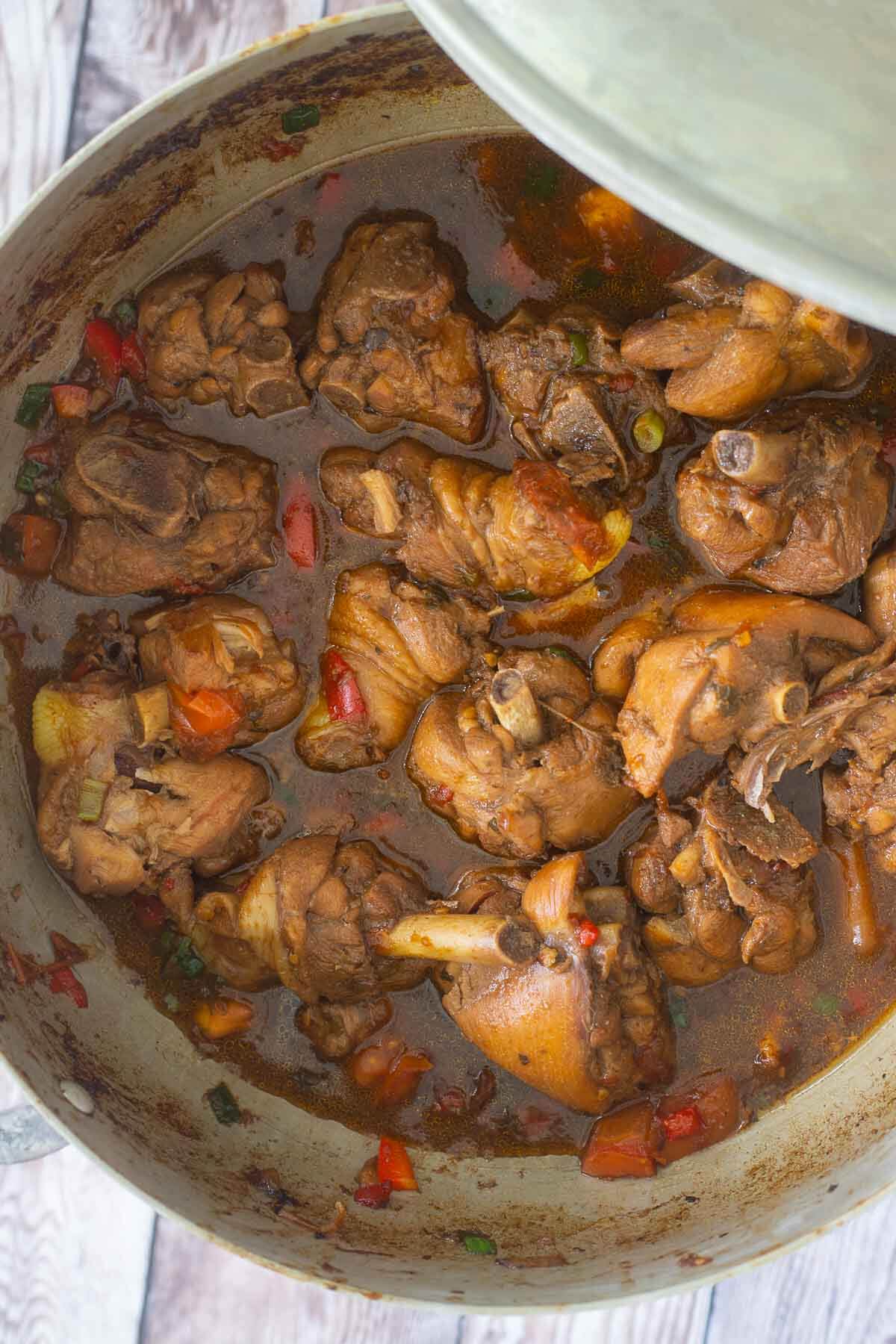 A picture of a large pot of trinidad stew chicken with