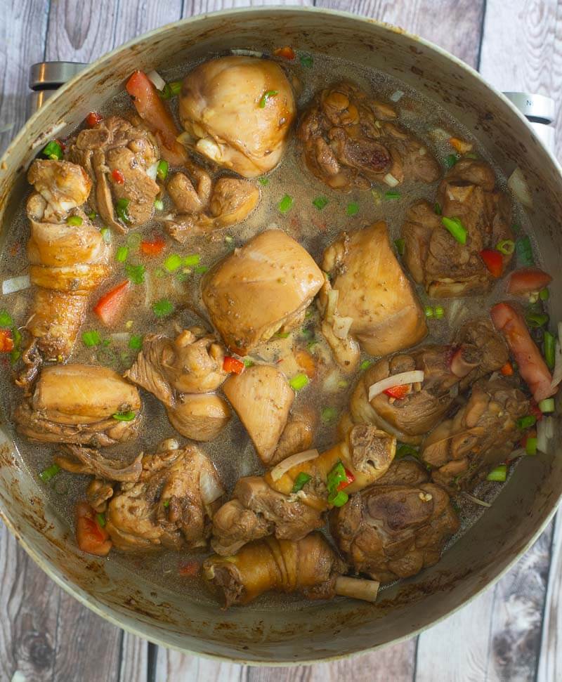 Stew chicken trini style being cooked down with additional seasonings.