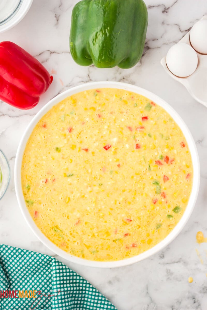 Combined batter for corn pie in a white bowl ready to bake.