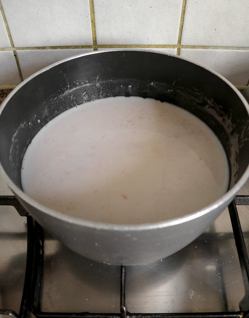 Rice and milk simmering on a stove to thicken.