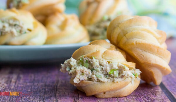 Two stuffed puffs face showing the fillings with a platter in the background