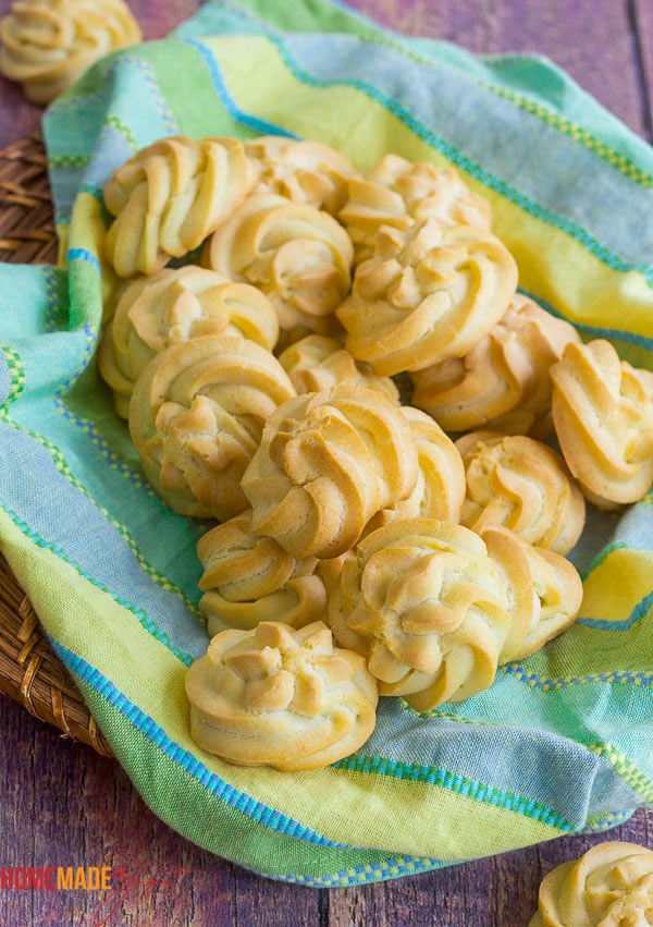 Unstuffed baked puff shells on a plaid napkin