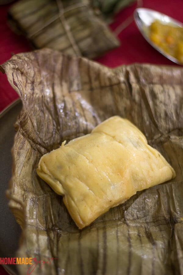 Opened banana leaf with an already steamed pastelle