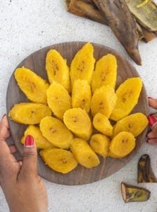 Slices of ripe boiled plantain spread out in a bowl.
