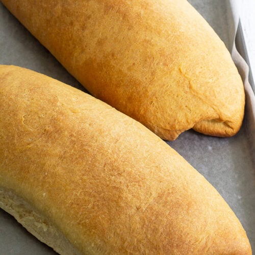 Golden brown baked Caribbean butter bread, in a tray.