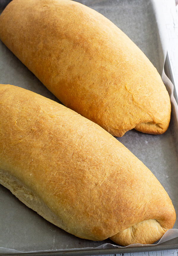 Golden brown baked Caribbean butter bread, in a tray.